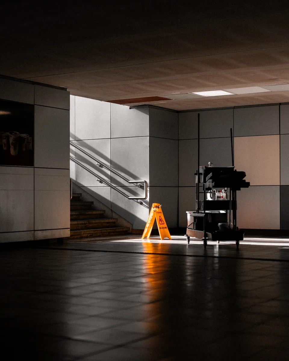 Cleaning trolley and wet-floor sign in a commercial facility