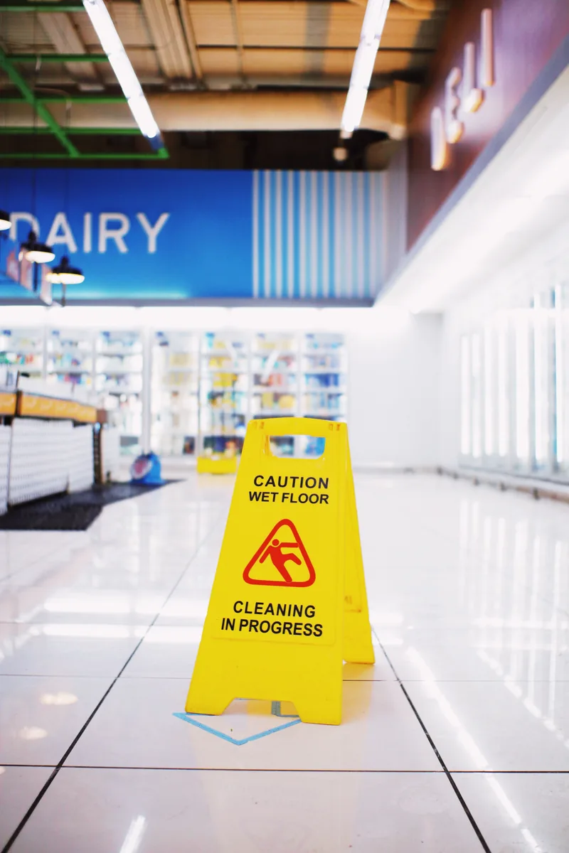 Wet-floor cleaning sign in a bright commercial interior